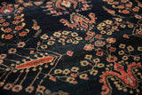 Textured deep navy field of the antique Sarouk rug, with bursting floral blossoms and palmette motifs.