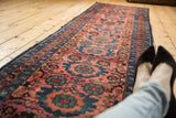 Vintage Lilihan runner featuring dusty raspberry floral patterns and intricate blue borders.