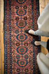 Vintage Lilihan runner with repeating floral medallions in dusty raspberry and sky blue.