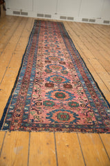 End detail of Lilihan runner, dusty raspberry field, sky blue floral motifs, secured end.