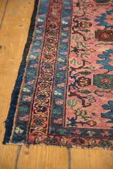 Secured side of the vintage Lilihan rug runner, with intricate blue and raspberry patterns.