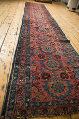 Dusty raspberry red and mallard green floral motifs with intricate vinery on a vintage Lilihan runner.