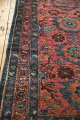 Vintage Lilihan runner edge; mallard green border, dusty raspberry floral vinery, worn pile texture.