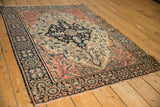 Antique Farahan Sarouk rug corner, showing classic palmette border and delicate vinery with dark navy, blush, and ivory.