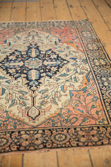 Antique Farahan Sarouk rug's dark navy palmette border and delicate ivory vinery field with even wear.