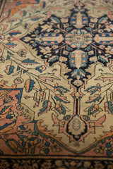 Antique Farahan Sarouk rug medallion with delicate vinery, serrated leaves in blush, navy, ivory.