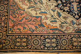 Antique Farahan Sarouk rug's dark navy roundel palmette border and ivory field vinery.