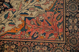 Antique Farahan Sarouk rug's delicate vinery, serrated leaves, dusty blush, tangerine, and palmette border.