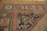 Antique Serab rug detail: geometric Herati spandrel with navy blue, sky blue, and blush.