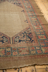 Antique Serab rug's Herati corner spandrel and wide geometric border with beige, navy, and blush.