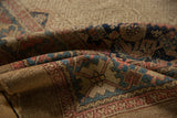 Hand-knotted antique Serab rug's wide border with Herati patterns in blue and blush.
