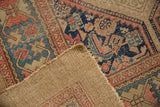 Detail of antique Serab rug: worn hand-knotted pile with beige, blue, blush patterns, and woven foundation.