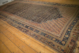 Antique Afshar carpet with dark navy field, germinating seed botehs, and stepped terra cotta.
