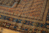 Antique Afshar carpet: germinating boteh field, geometric borders in navy, terra cotta, ivory, wear visible.