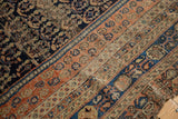 Antique Afshar carpet's intricate navy field and detailed terra cotta and beige borders, showing even wear.