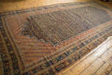 Intricate terra cotta and navy borders with secured edge on an antique Afshar carpet corner.
