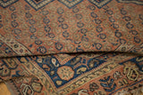 Folded antique Afshar carpet, showing terra cotta seed boteh field and navy blue border.