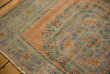 Worn apricot, royal blue, and mint floral guls on a vintage distressed Oushak rug.