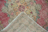 Vintage Oushak runner corner folded, showing distressed pile texture, fringe, and hand-knotted reverse.