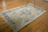 Distressed Oushak runner border detail, faded blue palmette motifs and worn texture.