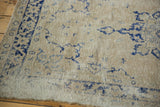 Distressed Oushak rug, hard etching to foundation, faded navy serrated patterns.