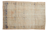Vintage distressed Oushak rug with faded ivory, dusty apricot, and subtle cobalt blue patterns.