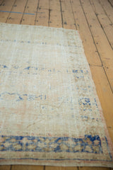 Distressed texture of a vintage Turkish Oushak rug showing mostly even wear in ivory, apricot, and navy.