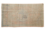 Distressed vintage Oushak runner with roundel medallion, featuring pale pink, blue, and green abrash. 2'9