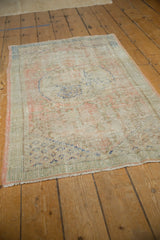 Distressed vintage Oushak runner close-up showing worn pile, pale pink, and deep sky blue vinery.