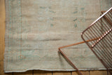 Faded pale beige and aqua distressed texture with fringe on vintage Turkish Oushak rug.