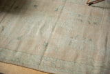 Distressed pile of a vintage Oushak rug, showing even wear and soft aqua tones.