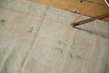 Distressed vintage Oushak texture, showing even wear, faint foundation, and aqua patterns.