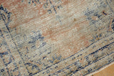 Distressed Oushak rug texture revealing exposed foundation with apricot, ivory, navy blue.