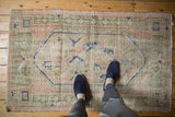 Distressed Vintage Oushak rug detail: Arts and Crafts pattern, ivory, navy, pink, sage.