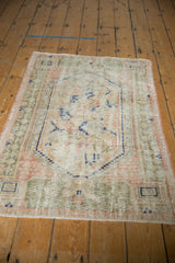 Vintage Distressed Oushak rug, showing even wear and faded ivory, blue, pink, sage tones.