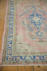 Distressed Oushak runner border, showing low pile, blue vinery on a dusty blush field.