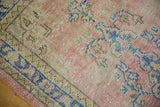 Distressed vintage Oushak rug runner showcasing dusty blush, blue, beige tones and subtle foundation wear.
