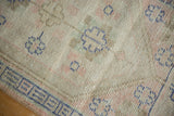 Distressed Oushak rug close-up: even wear to knot heads, faint foundation showing.