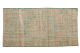 Distressed vintage Oushak runner, faded ocean green, pale rose, ivory, beige, roundel medallion. 2'8