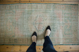 Faded ocean green and pale rose tones of a distressed vintage Oushak runner.
