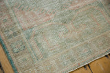 Vintage Oushak rug detail showing distressed low pile, even wear, and faint ocean green patterns.