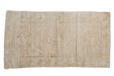 Distressed Oushak rug featuring faded blush, beige, and sand tones with a subtle medallion, 2'6