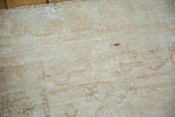 Distressed Oushak rug pile with pale blush, sand tones and visible foundation etching.