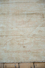 Distressed Oushak rug pile, with pale coffee brown, sand tones, showing mostly even wear and etching.