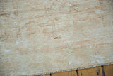 Distressed vintage Oushak rug pile showing low wear, exposed knot heads, and foundation etching.