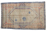 Distressed Oushak rug with Arts and Crafts floral medallion in ivory, dusty blue, pale pink.