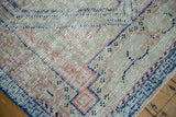 Distressed Oushak rug texture showing even wear to knot heads, ivory, blue, pink tones.
