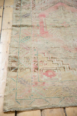 Distressed vintage Oushak rug pile with faint foundation, blush, and ivory stepped pattern.