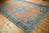 Worn side of distressed Turkish Oushak rug, showing blue palmette border.