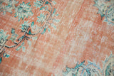 Distressed Oushak carpet pile with terra cotta, ivory, and mint green floral vinery.